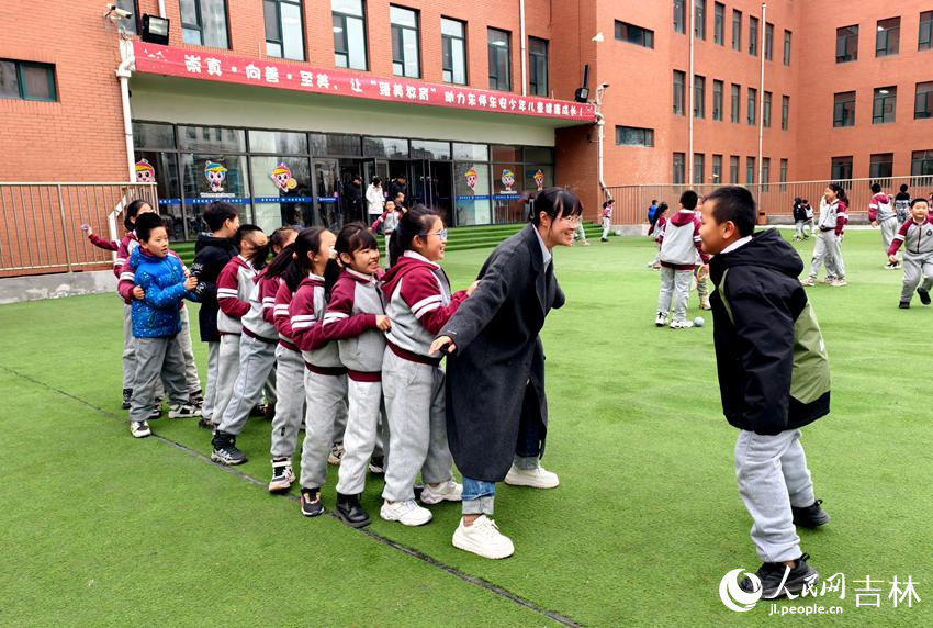 課間老師與學(xué)生們玩老鷹捉小雞。人民網(wǎng)記者 關(guān)思聰攝