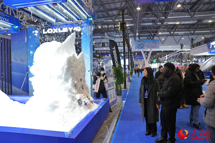 觀眾在雪博會上觀看機器造雪過程。人民網記者 李洋攝